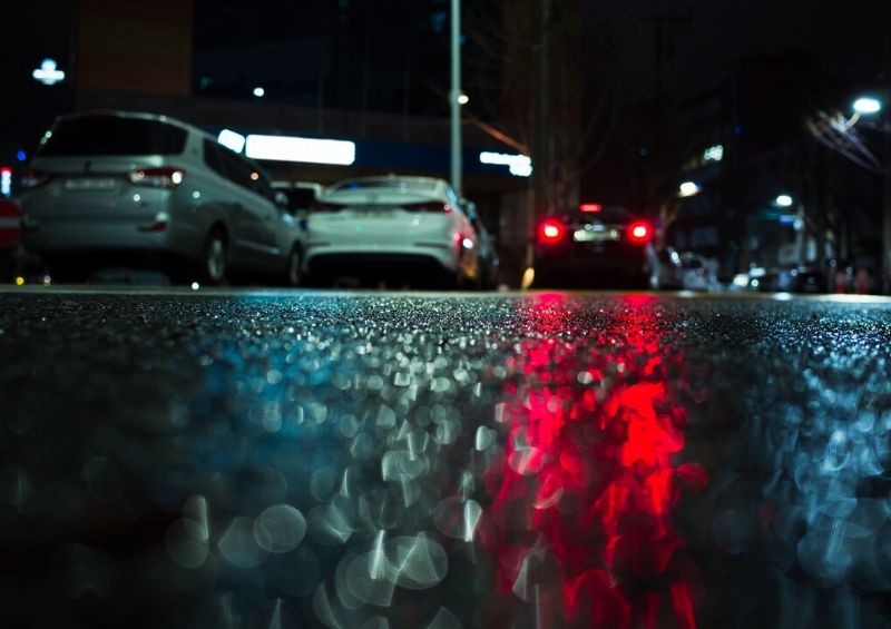 Cars parked at night in the rain